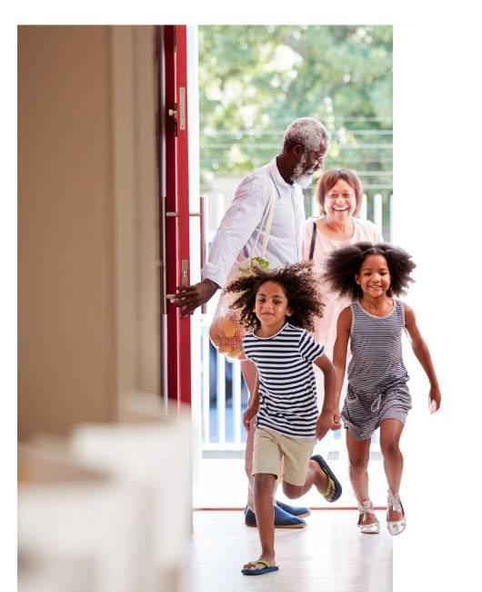 Family entering home through front entry door.