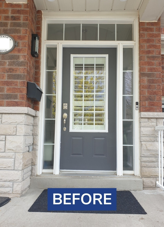 Before image from a black steel entry door replacement project in North York.