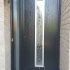 Black fiberglass entry door with off set glass insert and frosted sidelite