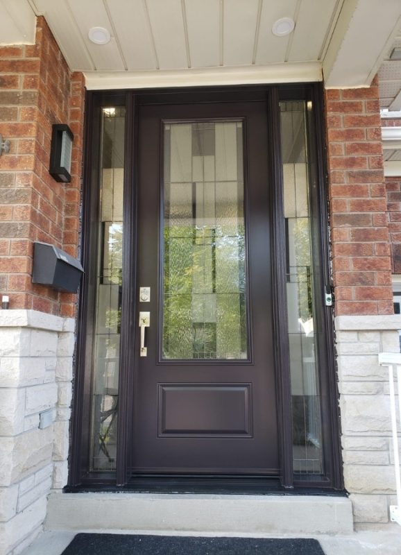 Black steel entry door in North York with decorative glass inserts and sidelites.