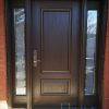 brown fiberglass door with panelled sidelites