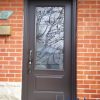brown steel entry door with rod iron glass insert