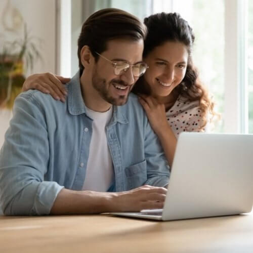 Couple booking consultation on computer.
