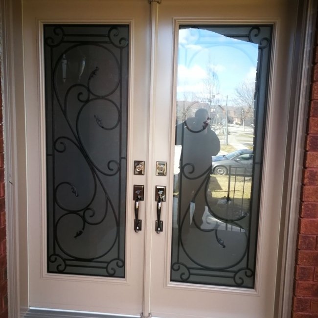 Double white entry door with large glass inserts.