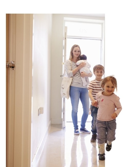 Family walking through their steel front door.