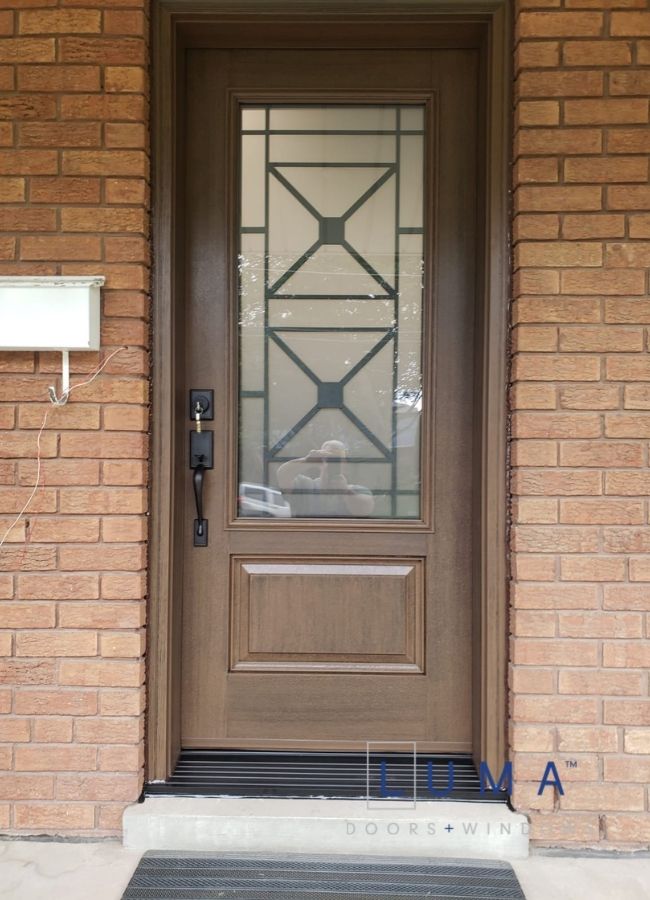 light brown fiberglass door with iron design glass