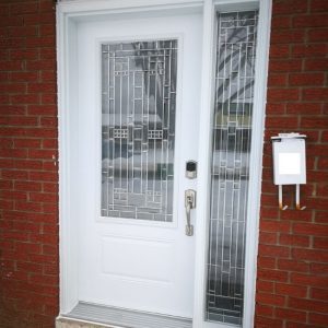 Steel white entry door with decorative glass insert and sidelite.