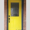 yellow steel door with stained glass