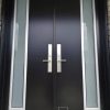 Modern Steel Double Door System, offset privacy glass design, painted black exterior with silver lite frames, silver multi point locking system