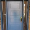 Modern Steel Door System, single door solid soho door with direct privacy glass sidelites and transom, painted blue exterior, peep hole, multi point locking system