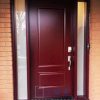 Steel Door System, solid 2 panel door slab, direct privacy glass sidelites, painted burgundy exterior, black sill, silver keypad lock