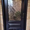 Steel Door, custom 42 inch wide slab, custom wrought iron design glass with executive panel below, painted dark brown exterior