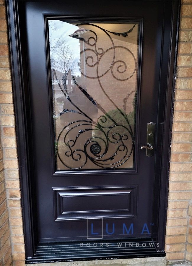 Steel Door, custom 42 inch wide slab, custom wrought iron design glass with executive panel below, painted dark brown exterior