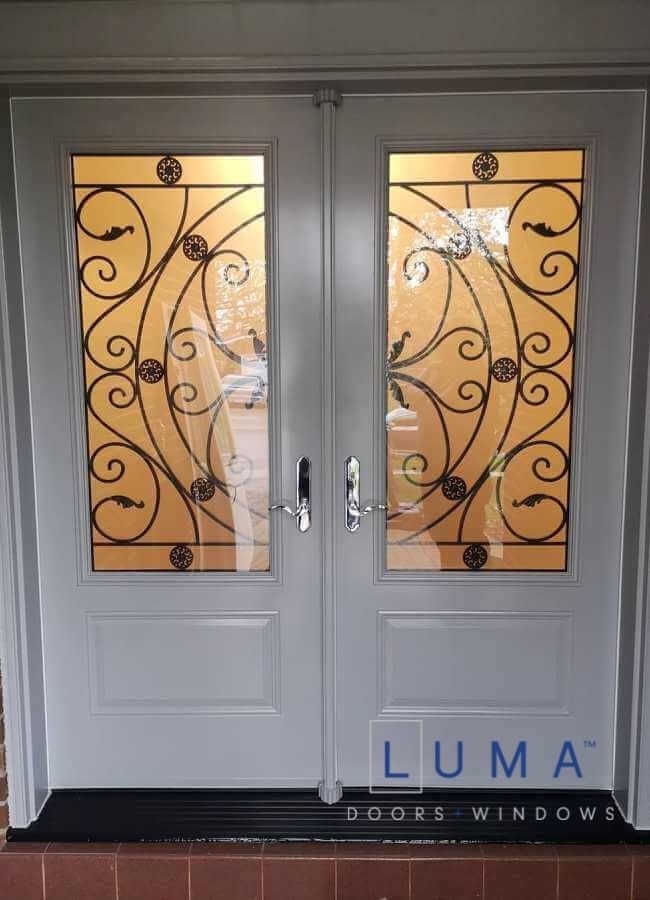 Steel Double Door System, 2 panel door slabs, 2248 Campbellsford Wrought Iron Glass design, multi point locking system, Capri silver lock, black threshold, painted dove grey exterior