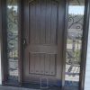 Fiberglass door system, Single oversized 42 inch x 8 foot tall slab. direct wrought iron sidlietes with full privacy, rustin nails (clovos) in door. stained dark brown exterior and interior, multi point locking system