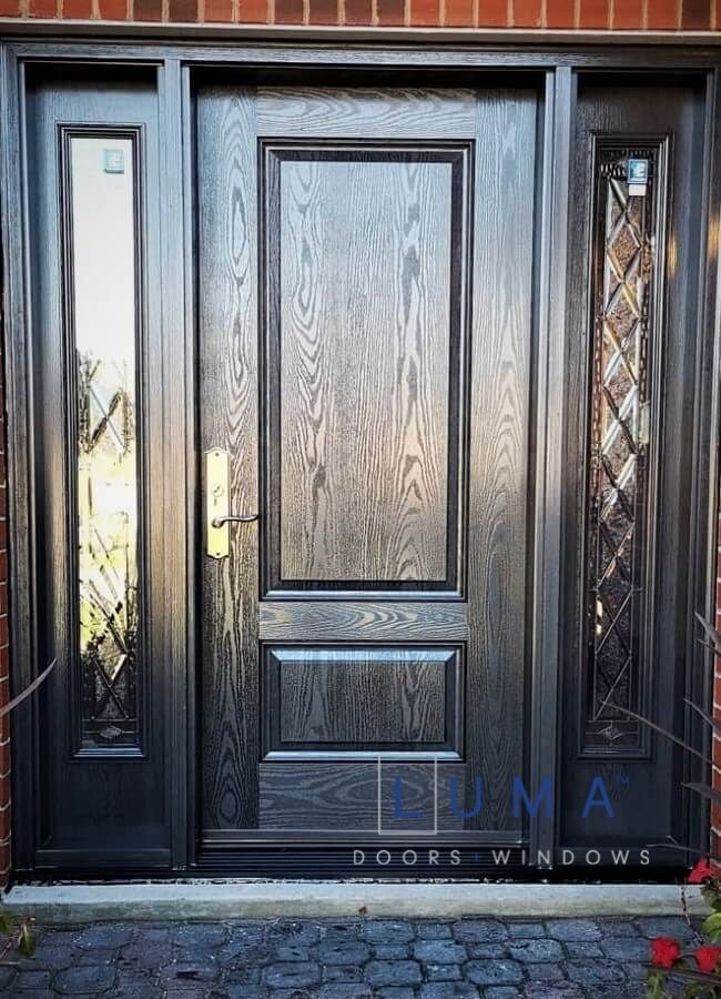 Fiberglass door system, Single door with 2 sidelites, oak grain 2 panel solid slab, panelled sidelited with 7x64 Trimlite Canterbury glass design sidelites, Charcoal stain in and out, multi point locking system