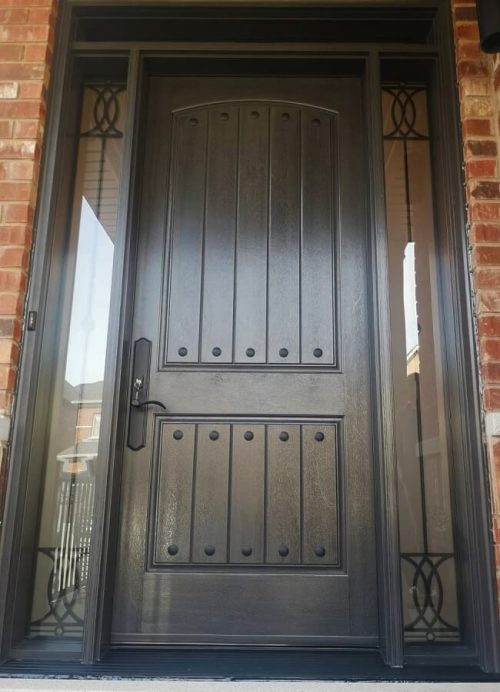Fiberglass door system. oversized 42inch by 8 foot tall mahogany door slab, rustic nails (clovos), multi point locking system with black hardware, laser cut wrought iron glass design sidelites