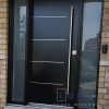 Modern Steel Door System. Single door with 2 direct glass sidelites, uno offset 4 aluminum line design slab, long round pull bar system, privacy glass sidelites, silver threshold, painted black exterior