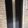 Modern Steel Door, centered narrow privacy glass design with modern flat glass frame, painted black exterior, black lock