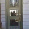 Modern single steel door, painted ivy green exterior, Novatech St. James glass design, silver threshold, silver modern lock