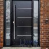 Modern Steel Door System. Uno 4 line offset aluminum design, long round pull bar, privacy direct glass sidelites, painted black exterior