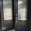 Steel Double door system, black exterior, 2 panel door slabs with 2248 Novatech Chanelle glass design